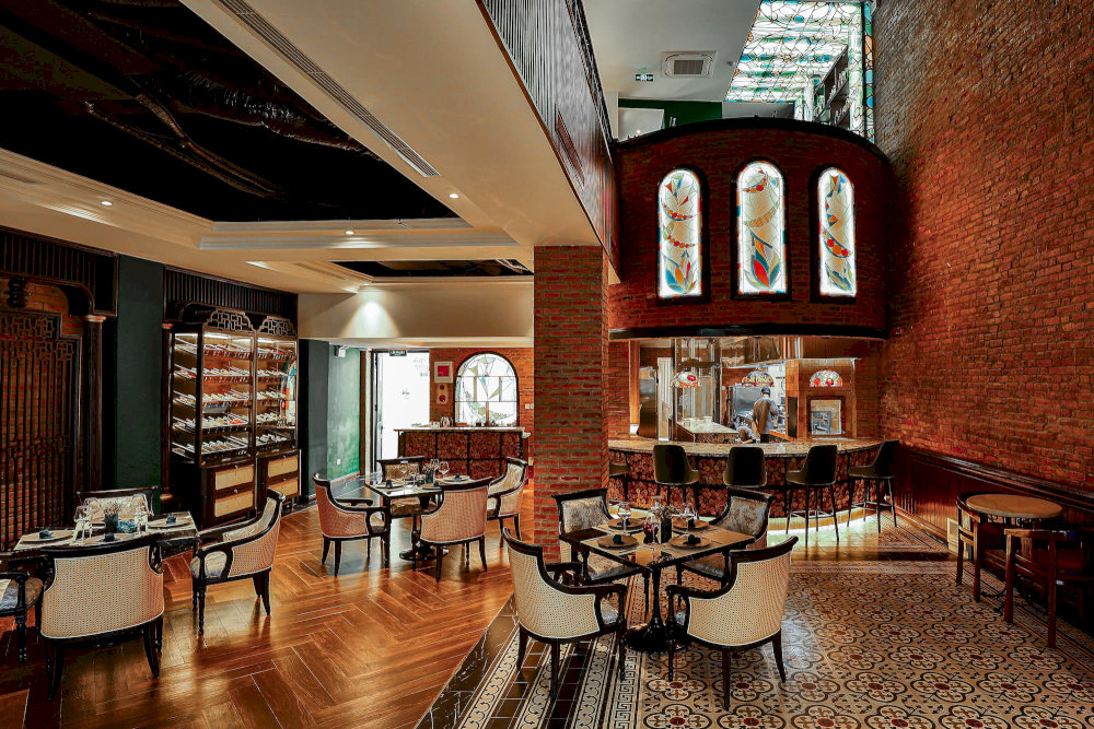 The restaurant’s Indochine-inspired décor and Gothic charm create a luxurious yet intimate setting